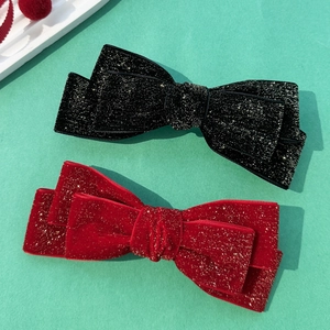 Velvet bow hair clips in black and wine red with sparkling gold glitter detail
