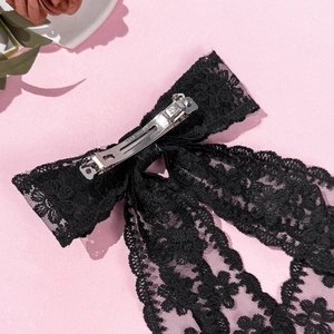 Elegant black double-layered lace bow hair clip with floral patterns and a metal spring clip