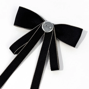 Back view of black JK uniform bowtie brooch with silver pin and long fabric ribbons