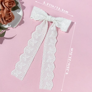Detail showing white lace bow hair clip with butterfly embroidery and size dimensions