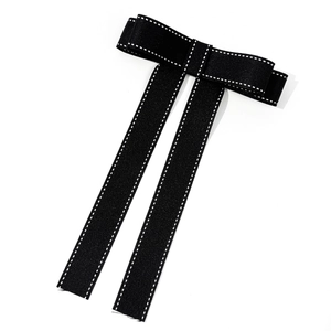 Classic black bow tie hair clip with white stitching and long ribbons in preppy style