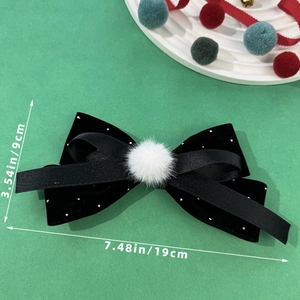 Elegant black velvet bow hair clip with white plush ball decoration for festive occasions