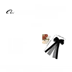 Detail showing dimensions of a black velvet and mesh bow hair clip with long ribbons