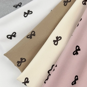 Bow print ribbed headband set in five colors including white, grey, and beige