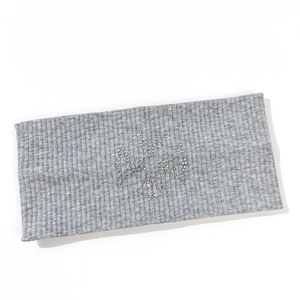 Detail of grey ribbed knit headband with sparkling silver rhinestone cross embellishment