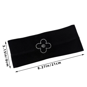 Black knitted elastic headband featuring a sparkling rhinestone flower and ribbed texture