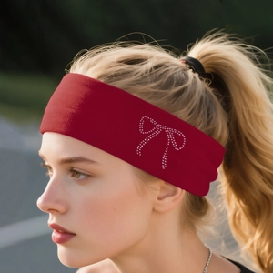 Detail of dark red knitted headband featuring a sparkling rhinestone bow decoration