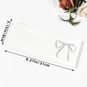 White knitted headband with rhinestone bow design, dimensions 21cm long by 8cm wide