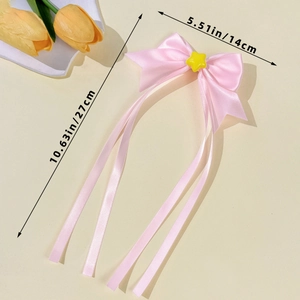 Pink ribbon bow hair clip with yellow star and size measurements of 27cm by 14cm