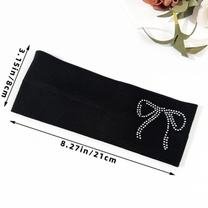 Detail view of black ribbed knit headband with rhinestone bow, size 21cm x 8cm