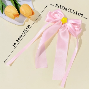 Pink ribbon bow hair clip with yellow star detail and dimension measurements shown