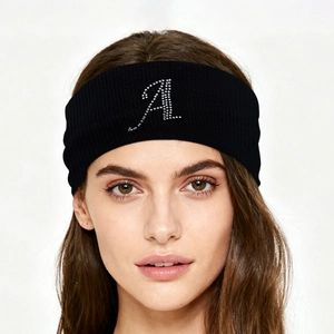 Detail of black knitted sports headband with a sparkling rhinestone letter A design