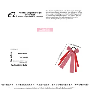 Detail view of red and white plaid ribbon bow hair clip with 14x27cm dimensions