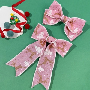 Fiocchi per capelli rosa di Natale con renne dorate e motivi di alberi su sfondo verde