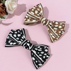 Set of 2 satin leopard bow hair clips in black and brown with elegant patterns