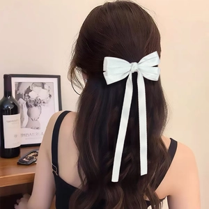 Elegant white satin hair clip featuring multi-layered long ribbons and silky texture finish
