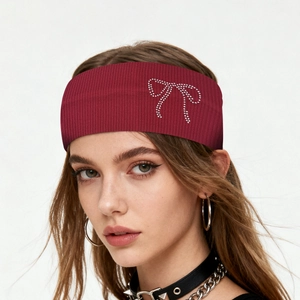 Detail shot of burgundy elastic wide headband featuring a rhinestone bow accent