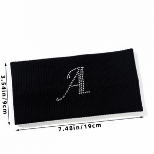 Detail view of black ribbed elastic headband with rhinestone letter A and size markings