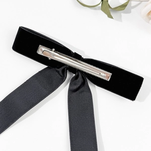 Elegant black velvet bow hair clip with long ribbon tassels and metal duckbill clip back