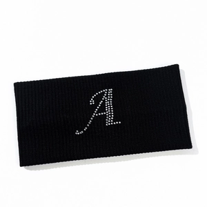 Close-up of sparkling rhinestone letter A on black ribbed elastic sports headband