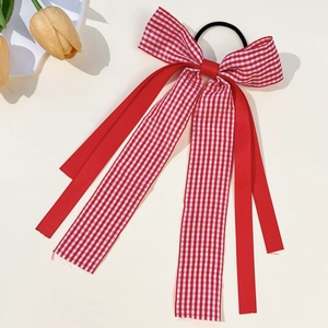 Detail of red and white plaid bow hair tie with long ribbons and yellow tulips