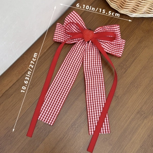 Detail view of red gingham bow hair clip with strawberry charm and long ribbons with size metrics