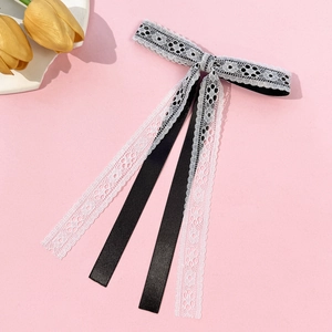 Detail of the elegant black ribbon and white floral lace layers on this sweet hair bow clip