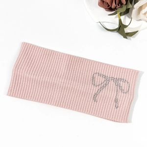 Pink ribbed knitted headband with rhinestone bow pattern and elegant flower decor