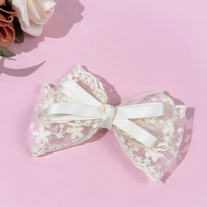 Elegant French lace bow hair clip in cream white with floral ribbon detail