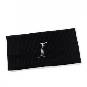 Close-up of black ribbed knit headband featuring a silver rhinestone letter I detail