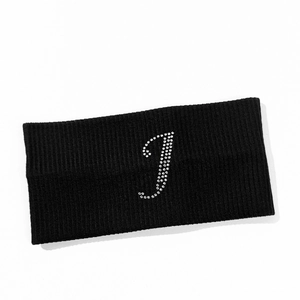 Close-up of black ribbed yoga headband featuring a sparkling rhinestone letter J