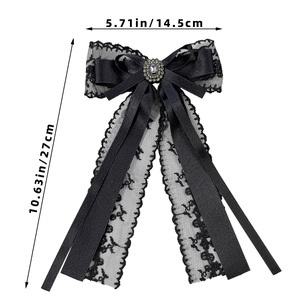 Detailed size view of a black lace bow hair clip with jewel and satin ribbon accents