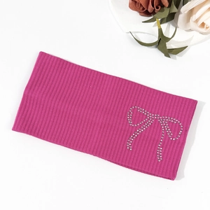 Close-up of rose red knitted headband featuring a sparkly rhinestone bow detail