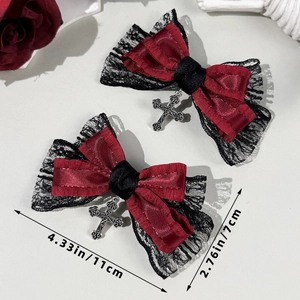 Detail of gothic hair clip with red satin, black lace, and silver cross pendant ornament