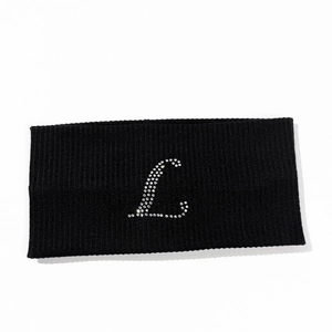 Detail showing letter L rhinestone design on black ribbed elastic yoga headband