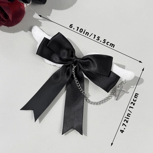Gothic black bow hair clip with angel wings, silver chains, and cross pendant detail