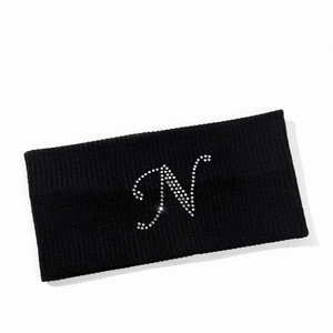 Detailed texture of black ribbed headband featuring a sparkling rhinestone letter N