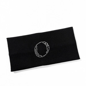 Macro detail of black ribbed knit headband featuring a sparkling silver rhinestone circle
