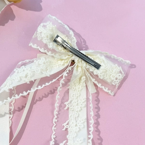 Elegant white lace bow hair clip with intricate floral mesh design and silver metal clip