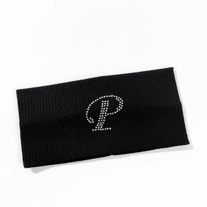 Detail of black ribbed knit headband with sparkling rhinestone letter P decoration