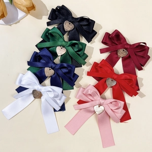 Set mit sieben eleganten Satin-Haarschleifen mit goldenem Herzanhänger in bunten Farben