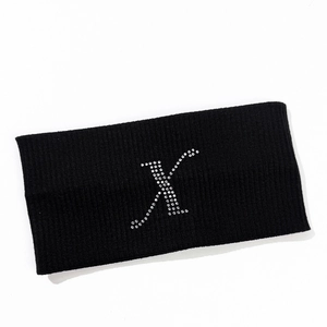 Detailed texture of black elastic headband featuring sparkling rhinestone letter X