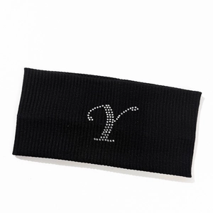 Detail of black ribbed knit headband with sparkling rhinestone letter Y decoration