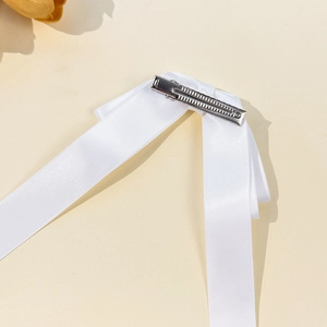 Elegant white ribbon bow hair clip with secure silver metal alligator clip for styling