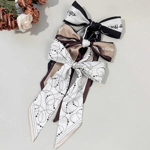 Elegant silk bow hair ribbons with letter prints and geometric patterns for women