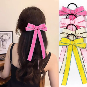 Detail of long ribbon bow hair scrunchies in multiple colors with ribbed fabric texture