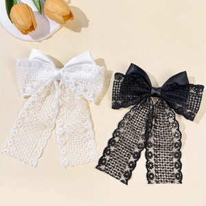 Elegant French lace bow hair clips in black and white with long flowing ribbons