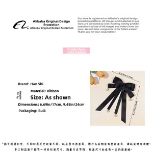 Detail view of black ribbon bow hair clip with pearl pendant showing 17cm by 24cm size