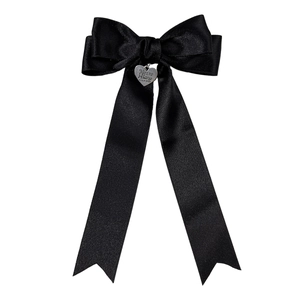 Elegant black satin bow hair clip with silver heart pendant on white background