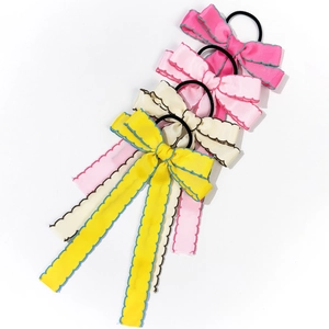 Bow hair scrunchies set with scalloped edges in yellow, beige, pink, and rose red